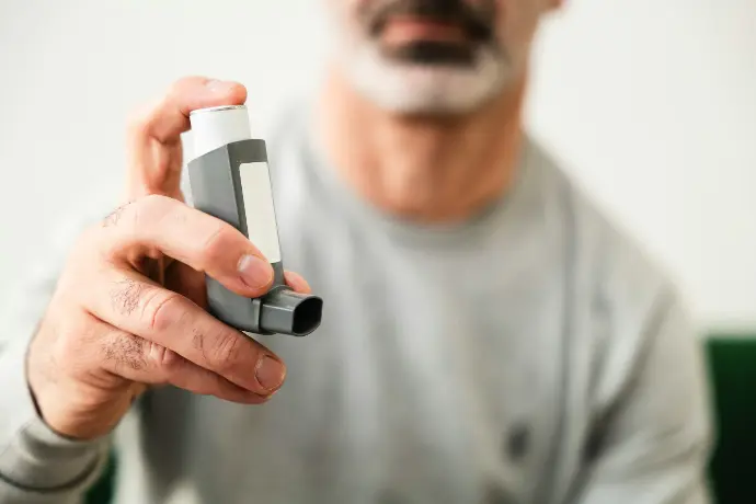 A man is holding a video game controller